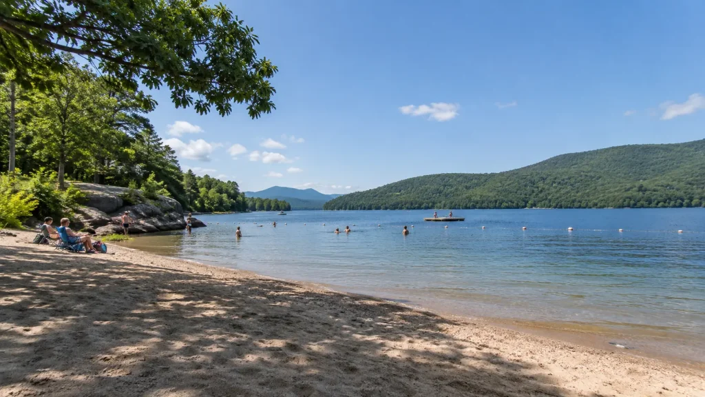Beach and swimming area in a New York State Park with calm water and visitor recreation